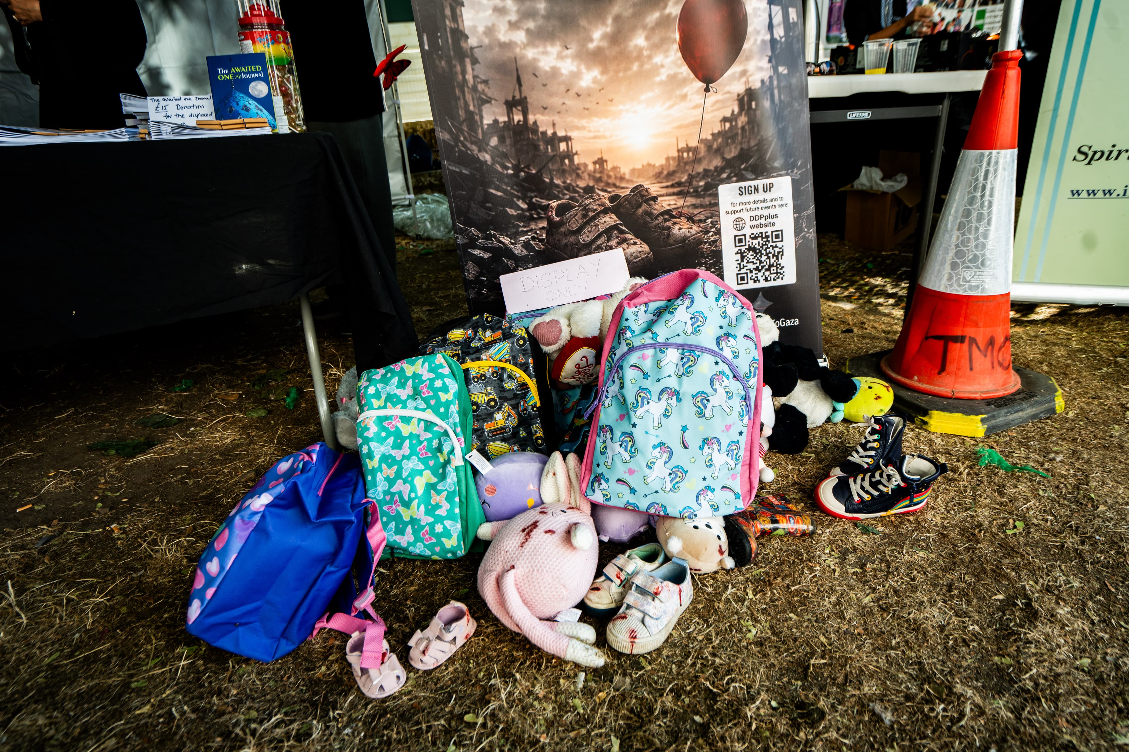 Backpacks, toys and children’s items gathered for remembrance.