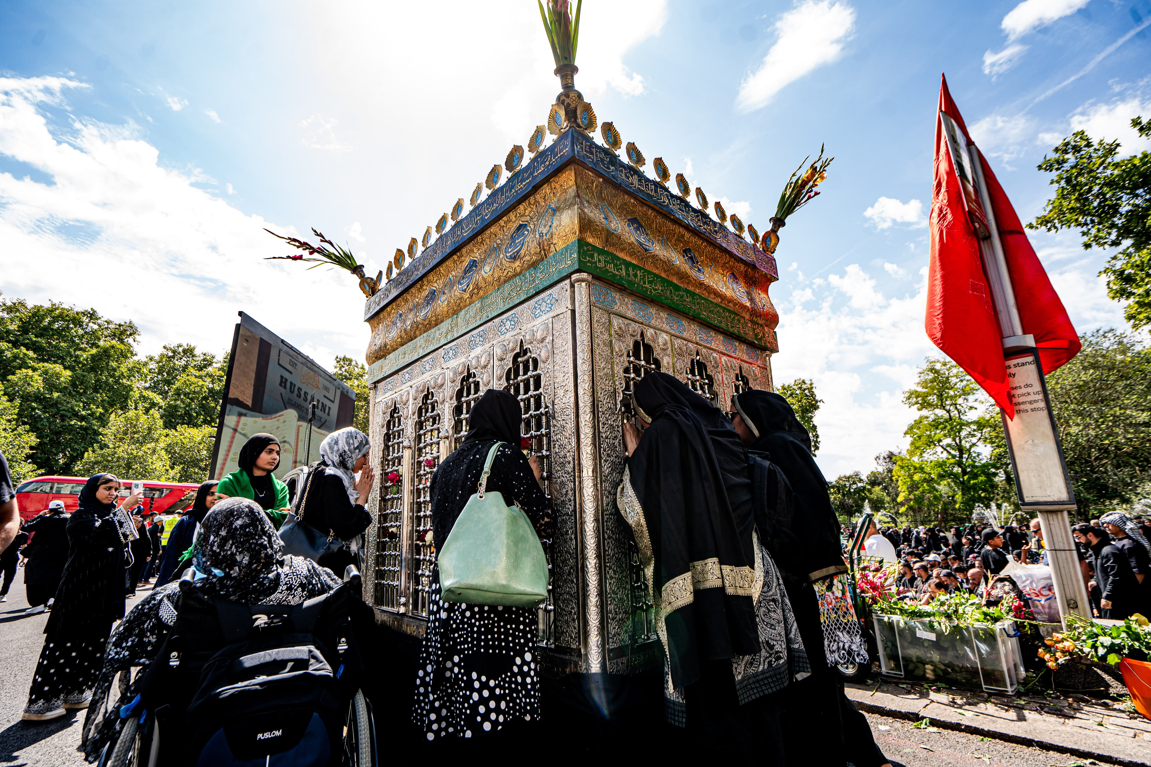 Visitors gathered around the decorated ceremonial structure.